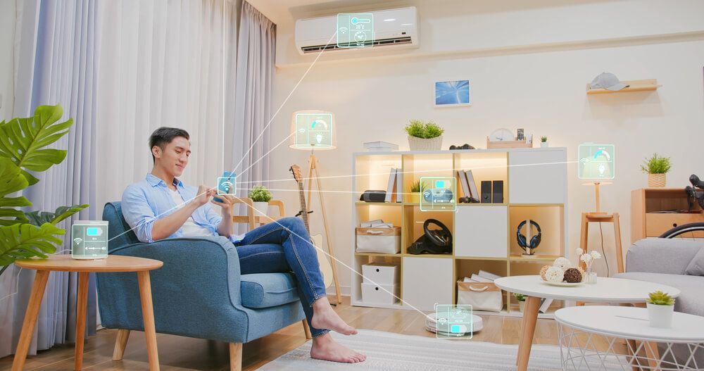 man using his phone to control devices in his room