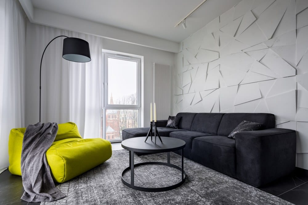 living room with textured wall paneling in 3D shapes