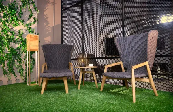 two comfortable chairs on artificial grass