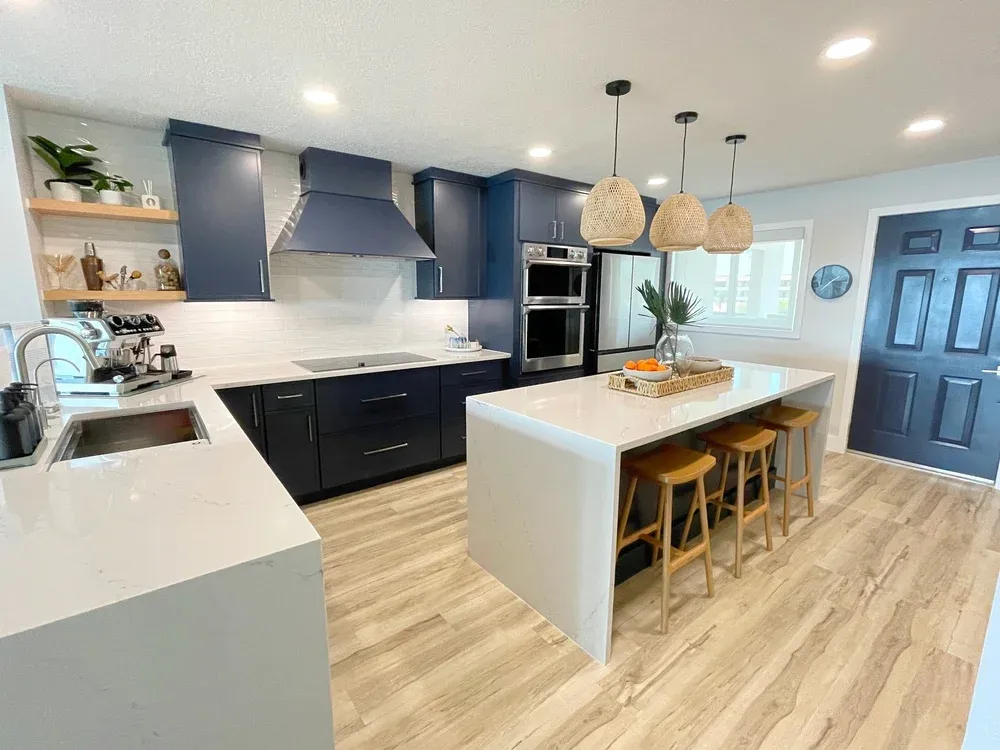 Coastal modern kitchen with oak wood, blue cabinets, and white countertops.